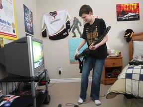 In this file photo, Austin Miles is pictured playing a video game in his Amherstburg, Ont. home January 31, 2009. A year has passed since the 13-year-old was caught in a snow grooming machine on a Michigan ski hill that seriously mangled his leg. (Windsor Star files)
