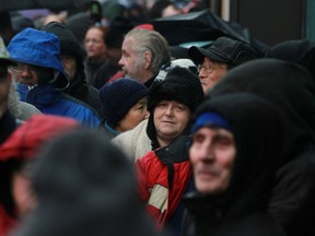 Hundreds lineup along the 300 block of Ouellette Ave. for the annual Mikhail Holdings turkey giveaway, Friday, Dec. 20, 2013. (DAX MELMER/The Windsor Star)