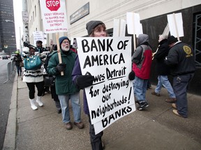 People protest outside the U.S. Courthouse where federal bankruptcy Judge Steven Rhodes is to rule on Detroit's Chapter 9 bankruptcy eligibility December 3, 2013 in Detroit, Michigan. Detroit is the largest city in U.S. history to file for bankruptcy.(Photo by Bill Pugliano/Getty Images)