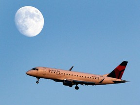 A Delta connection airplane approaches LaGuardia airport, in New York.  (AP Photo/Charles Krupa)
