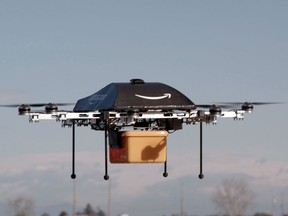 This undated handout photo released by Amazon on December 1, 2013 shows a flying "octocopter" mini-drone that would be used to fly small packages to consumers. Amazon CEO Jeff Bezos revealed on December 1 that his company was looking to the future with plans to use mini-drones to deliver small packages. (AFP PHOTO / AMAZON)