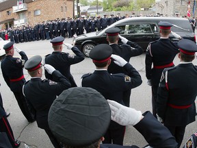 In this 2006 file photo, police officers from across North America form a solemn honour guard for the hearse carrying the body of slain Windsor police officer John Atkinson. (Nick Brancaccio/The Windsor Star)