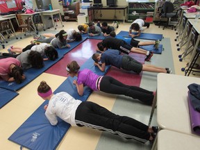 Grade 7 students from Holy Cross Catholic Elementary School in LaSalle take part in a plank challenge on December 17, 2013. (JASON KRYK/The Windsor Star)