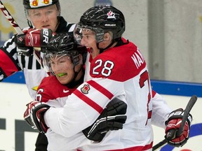 Team Canada forward Anthony Mantha (28) celebrates his goal against Germany with teammate Curtis Lazar during first period qualification round IIHF World Junior Hockey Championships in Malmo, Sweden on Thursday December 26, 2013. (THE CANADIAN PRESS/ Frank Gunn)