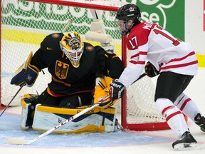 Team Canada forward Connor McDavid (17) wraps around to shoot on Germany goaltender Marvin Cupper during third period qualification round IIHF World Junior Hockey Championships action in Malmo, Sweden on Thursday December 26, 2013. (THE CANADIAN PRESS/ Frank Gunn)