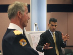 Windsor mayor Eddie Francis (R) speaks Tues. Dec. 10, 2013, during a media conference in Windsor, Ont. regarding restructuring of the Windsor Fire and Rescue Services as chief Bruce Montone looks on. (DAN JANISSE/The Windsor Star)