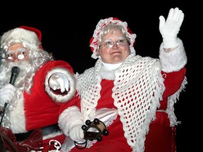 Santa and Mrs. Claus talk and wave to the crowds of people lined down Erie Street North for the Santa Claus Parade in Leamington Saturday, Nov. 30, 2013. (JOEL BOYCE/The Windsor Star)