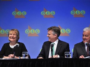 OLG's president and CEO Rod Phillips, centre, and Mike Hamel, OLG's Director of Corporate Investigations, announce Kathryn Jones, left, of Hamilton as the identified winner of the outstanding $50-million LOTTO MAX jackpot from the Nov. 30, 2012 draw, at a news conference in Toronto, Tuesday, Dec. 3, 2013. (THE CANADIAN PRESS/HO-Ontario Lottery and Gaming Corp.)