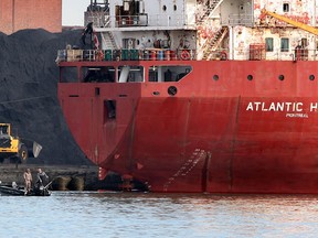 Fishermen troll for walleye on the Detroit River in front of Canadian Steamship Lines freighter Atlantic Huron which was taking on a load of petroleum coke April 15, 2013. (NICK BRANCACCIO/The Windsor Star)