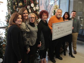 Stephanie MacDonald, left, Paula Schmidt, Wendy Sexton, Judith Funkenhauser,  Gunther Funkenhauser, Marla Funkenhauser-Wiper, and Eric Funkenhauser during a formal donation by the Funkenhauser family to Hotel-Dieu Grace Healthcare at the Tayfour Campus on December 1, 2013.  The $23,000 was raised in the 2013 Day for a Life Golf Tournament and the inaugural Pass It On fashon show in honour of their son Trevor.  The family continues to raise funds for organ donor awareness in memory of their son. (JASON KRYK/The Windsor Star)