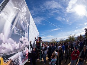 Fans sign a giant poster of Paul Walker at his Fan Memorial on December 8, 2013 in Valencia, California. (Photo by Valerie Macon/Getty Images) O