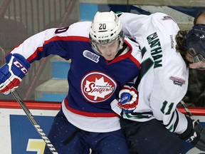 Windsor's Andrew Burns, left, checks Connor Chatham of the Whalers at the WFCU Centre Tuesday. (NICK BRANCACCIO/The Windsor Star)