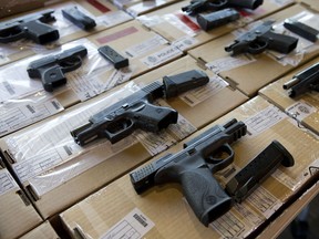 Toronto police display firearms seized as part of Project Traveller, a province-wide crackdown on smuggled guns that included several raids, seizures and arrests in Windsor. (Matthew Sherwood/Postmedia News)