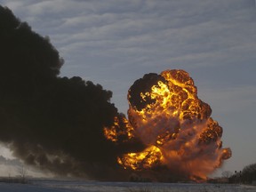A fireball goes up at the site of an oil train derailment Monday, Dec 30, 2013, in Casselton, N.D. The train carrying crude oil derailed near Casselton Monday afternoon. Several explosions were reported as some cars on the mile-long train caught fire. (AP Photo/Bruce Crummy)
