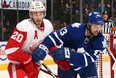 Toronto's Nazem Kadri, right, is checked by Detroit's Drew Miller at the Air Canada Centre. (Photo by Abelimages/Getty Images)