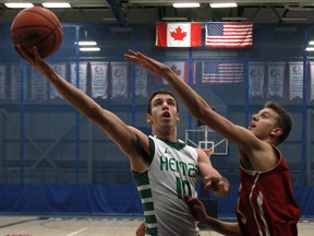 Herman's Marko Kovac, left, is guarded by Cardinal Newman's Marcus Zeba in the semifinal of the 57th Annual Invitational High School Basketball Tournament at the St. Denis Centre. (DAX MELMER/The Windsor Star)