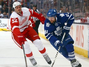 Toronto's Phil Kessel, right, is checked by Detroit's Jonathan Ericsson at the Air Canada Centre on Dec. 21, 2013. (Photo by Abelimages/Getty Images)