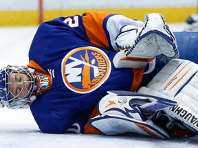 New York goalie Evgeni Nabokov stops a shot against the Red Wings Monday. (AP Photo/Paul Sancya)