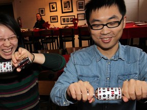 University of Windsor graduate students Shirley He, left, and Dan Liu, both of China, enjoy the festive spirit at Green Bean Cafe annual Christmas Community dinner for those who are staying around the campus of University of Windsor, December 25,  2013.  (NICK BRANCACCIO/The Windsor Star)