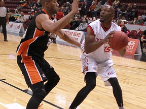 Windsor's Quinnel Brown, right, is guarded by Ottawa's Mike Rose at the WFCU Centre. (DAX MELMER/The Windsor Star)