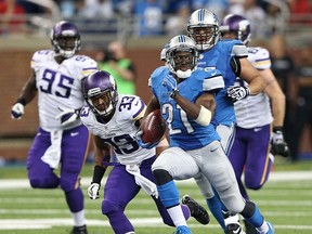 Detroit's Reggie Bush, right, runs for a 77-yard touchdown against the Vikings at Ford Field. (Photo by Leon Halip/Getty Images)