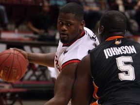 Windsor forward DeAndre Thomas, left, is covered by Ottawa's Jermaine Johnson at the WFCU Centre. (TYLER BROWNBRIDGE/The Windsor Star)