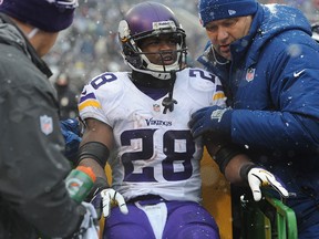 Vikings running back Adrian Peterson is taken off the field after being injured against the Ravens at M&T Bank Stadium. (Photo by Larry French/Getty Images)