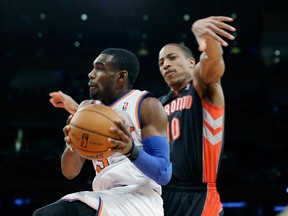 New York's Tim Hardaway Jr. drives past Toronto's DeMar DeRozan Friday. (AP Photo/Frank Franklin II)