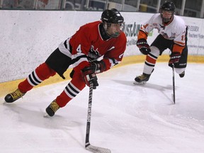 Tecumseh's Conner Tazzman, left, is checked by Austin VandenBerg of the Essex Ravens during the 54th Riverside Annual International Bantam-Midget Tournament at the WFCU Centre. (DAX MELMER/The Windsor Star)