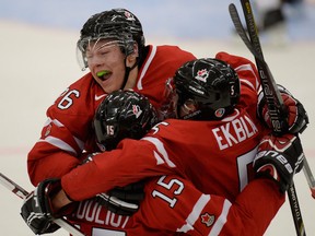 Belle River's Aaron Ekblad, right, celebrates a goal with Curtis Lazar, top, and Derrick Pouliot against the Czech Republic at the IIHF World Junior Hockey Championship Saturday in Malmo, Sweden. (THE CANADIAN PRESS/ Frank Gunn)