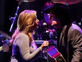 Trisha Yearwood and Garth Brooks perform during Playin' Possum! The Final No Show Tribute To George Jones - Show at Bridgestone Arena on November 22, 2013 in Nashville, Tennessee.  (Photo by Terry Wyatt/Getty Images)