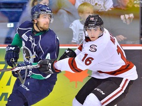Guelph's Brody Milne, right, checks Plymouth's Nick Malysa. (Terry Wilson/OHL Images)