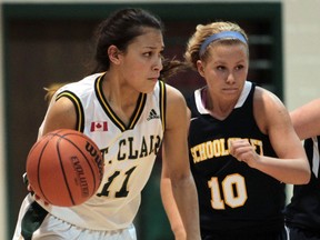 St. Clair's Meghen Boyd, left, is pressured by the Schoolcraft College Ocelots in exhibition basketball action at St. Clair College. (JASON KRYK/The Windsor Star)