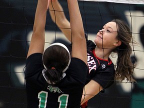 Essex's Jessica Kimball, right, spikes the ball past Herman's Tricia Alexander  in high school girls volleyball. (TYLER BROWNBRIDGE/The Windsor Star)