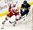 Detroit's Henrik Zetterberg, left, is checked by Pittsburgh's Kris Letang. (AP Photo/Keith Srakocic)