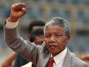 Anti-apartheid leader and African National Congress (ANC) member Nelson Mandela raises clenched fist, arriving to address mass rally, a few days after his release from jail, 25 February 1990, in the conservative Afrikaaner town of Bloemfontein, where ANC was formed 75 years ago. AFP PHOTO / TREVOR SAMSON