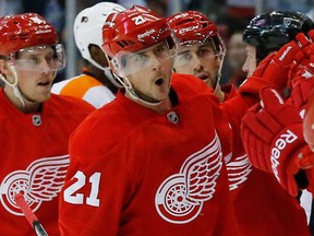 Detroit's Tomas Tatar, centre, celebrates his goal against the Flyers in the first period Wednesday in Detroit. (AP Photo/Paul Sancya)