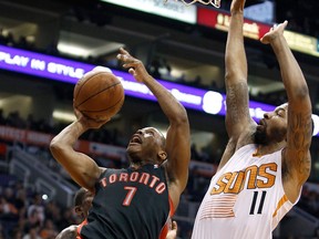 Toronto's Kyle Lowry, left, drives to the basket against Phoenix's Markieff Morris Friday during the second half in Phoenix. (AP Photo/Ralph Freso)
