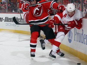 Detroit's Daniel Alfredsson, right, is checked by New Jersey's Patrik Elias at the Prudential Center. (Photo by Bruce Bennett/Getty Images)