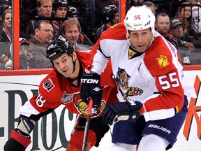 Florida's Ed Jovanovski, right, is checked by Ottawa's Zenon Konpka. (Photo by Wayne Cuddington/Ottawa Citizen)