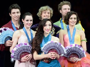 University of Windsor student Tessa Virtue and Scott Moir, from left, France's Nathalie Pechalat and Fabian Bourzat and Meryl Davis and Charlie White of the United States pose for photographers at the ISU figure skating Grand Prix Final in Japan Saturday. (AFP PHOTO/Toru YAMANAKATORU YAMANAKA/AFP/Getty Images)