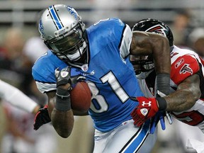 Detroit's Calvin Johnson, left, breaks the tackle of Atlanta's William Moore last season in Detroit. The Lions and Falcons will play at Wembley Stadium in LOndon nest season. (Gregory Shamus/Getty Images)