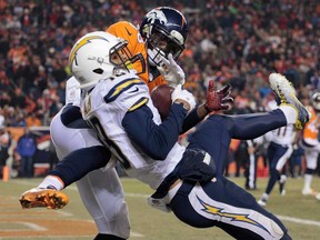 San Diego wide receiver Keenan Allen, front, catches a pass for a touchdown against Denver cornerback Kayvon Webster Thursday, Dec. 12, 2013, in Denver. (AP Photo/Joe Mahoney)