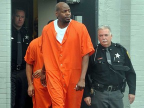 Former Raptor Keon Clark, left, exits the Vermilion County Courthouse in Danville, Ill., on Wednesday after he was sentenced to eight years in prison on weapons and driving under the influence charges. (AP Photo/News-Gazette, Rick Danzl)