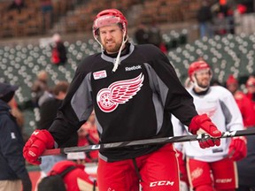 Detroit's Niklas Kronwall walks out to the outdoor rink for practice at Comerica Park Wednesday, Dec. 18, 2013, in Detroit. (AP Photo/Detroit News, David Guralnick)
