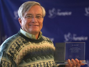 Jim Gall poses with the Glenn Sawyer Service Award he recently received from the Ontario Medical Association. (DAN JANISSE/The Windsor Star)