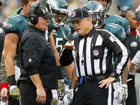 Eagles head coach Chip Kelly, left, talks to an official during a game against the Redskins November 17, 2013 in Philadelphia. (Rich Schultz /Getty Images)