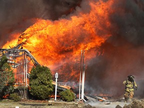 A home in the 1000 block of Esdras Place is engulfed in flames Mar. 24, 2011, in Windsor, Ont. (DAN JANISSE/The Windsor Star)