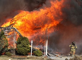 A home in the 1000 block of Esdras Place is engulfed in flames Mar. 24, 2011, in Windsor, Ont. (DAN JANISSE/The Windsor Star)