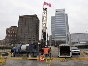Workers drill at the foot of Ouellette Avenue on Dec. 2, 2013, to test for depth for the Great Canadian Flag Project. (Dan Janisse / The Windsor Star)